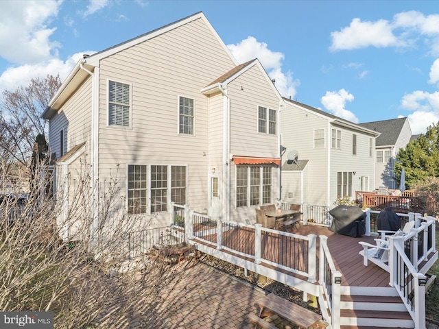 rear view of house featuring a deck