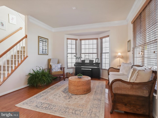 living room with crown molding and hardwood / wood-style floors