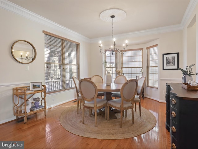 dining space with hardwood / wood-style flooring, ornamental molding, and a wealth of natural light