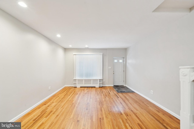 foyer with radiator and light hardwood / wood-style flooring