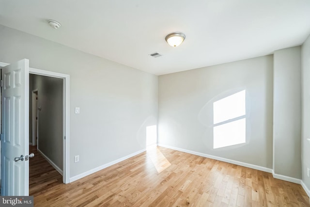 empty room with wood-type flooring