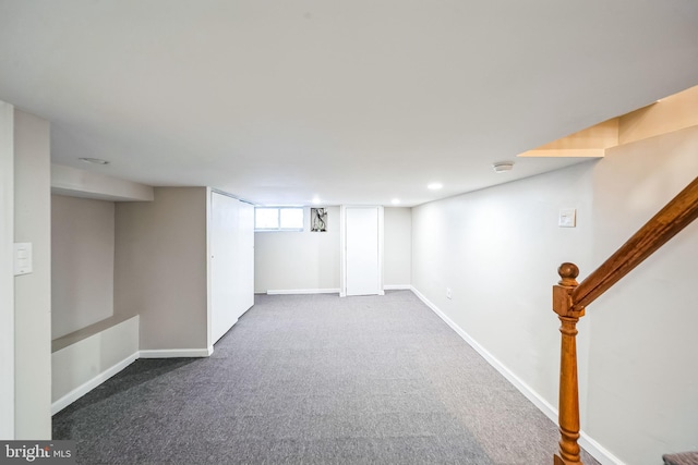 basement featuring dark carpet