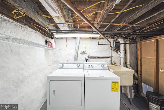 laundry room with sink and washer and clothes dryer