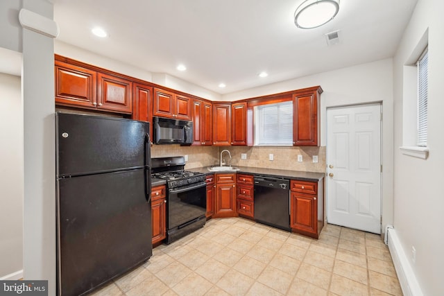 kitchen featuring baseboard heating, sink, backsplash, and black appliances