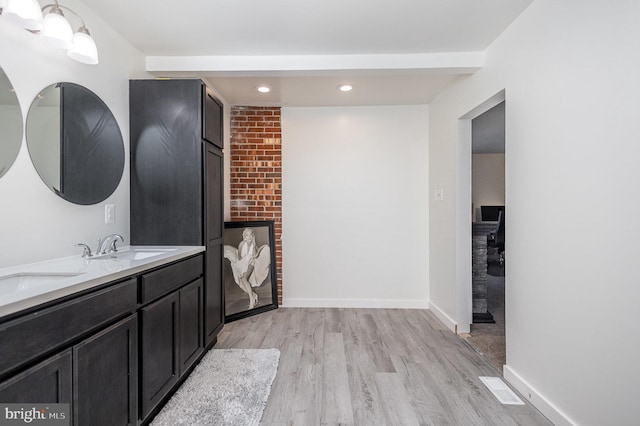 bathroom with hardwood / wood-style floors and vanity