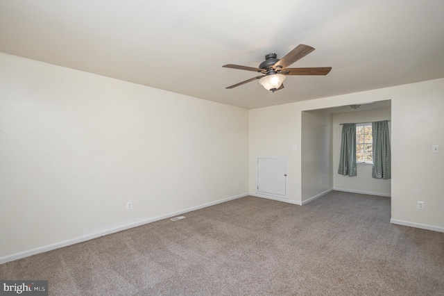 empty room featuring ceiling fan and carpet floors