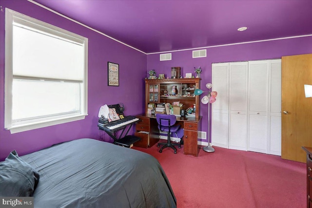 carpeted bedroom with a closet