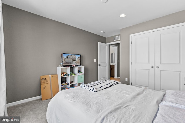 bedroom with light colored carpet and a closet