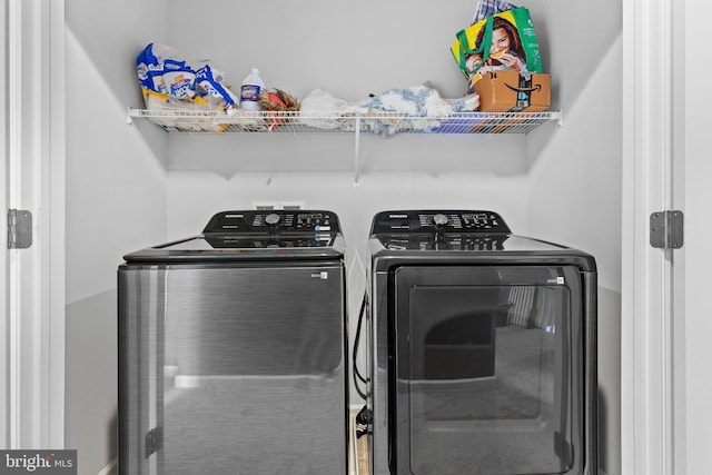 clothes washing area featuring washer and dryer