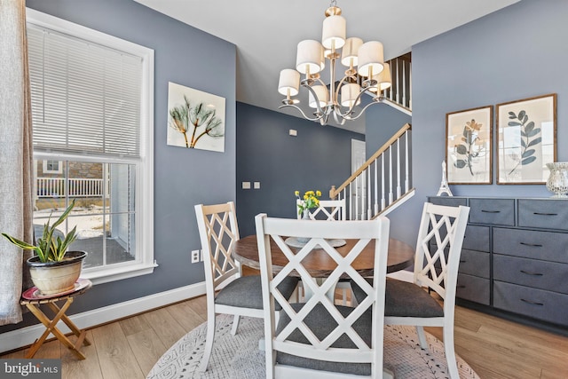 dining space featuring a notable chandelier and light hardwood / wood-style flooring