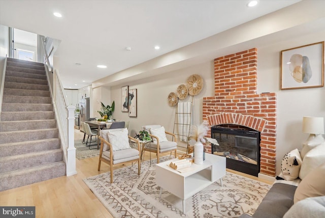 living room with a fireplace and light hardwood / wood-style floors