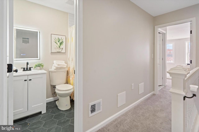 bathroom with toilet and vanity