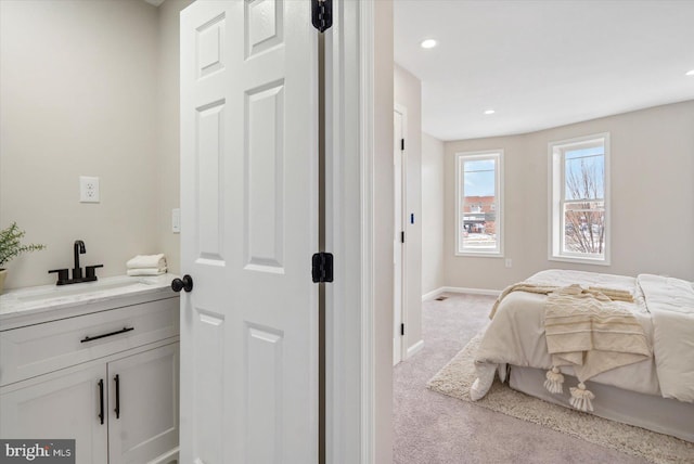 carpeted bedroom featuring sink