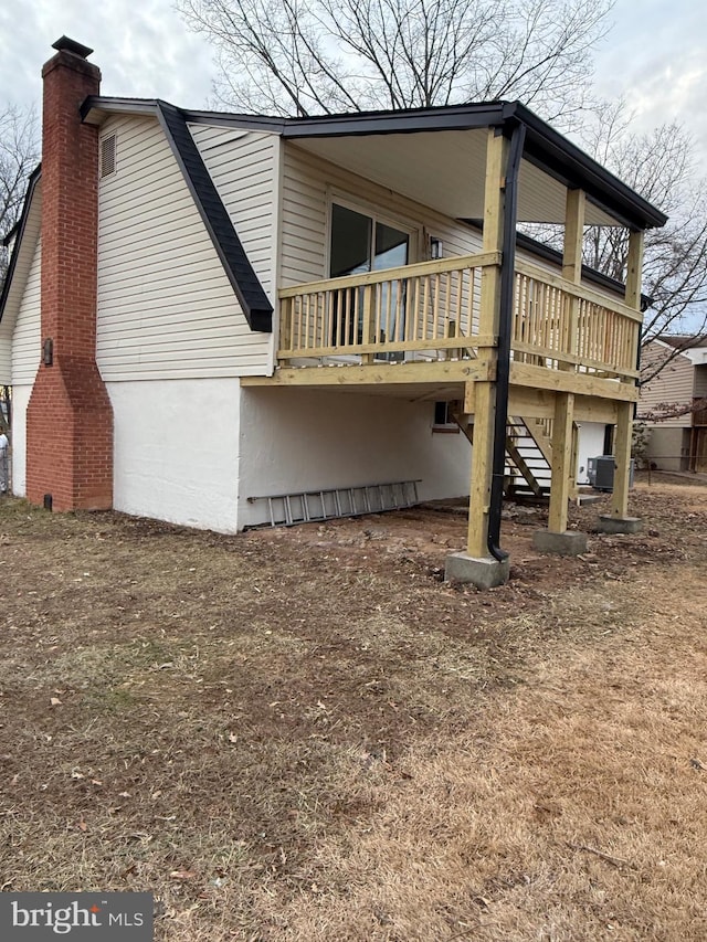 rear view of house with a wooden deck