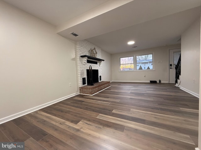 unfurnished living room with dark wood-type flooring