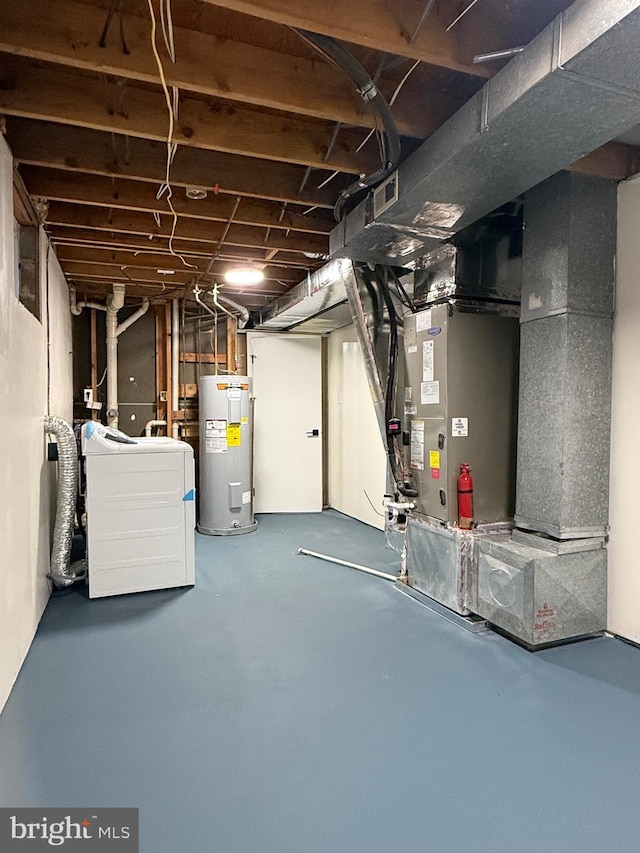 basement with water heater and washer / clothes dryer