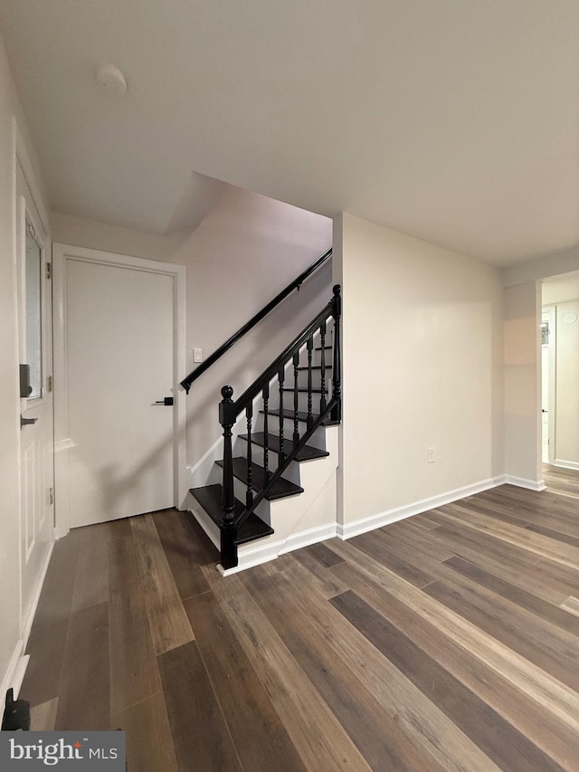 stairs with hardwood / wood-style flooring