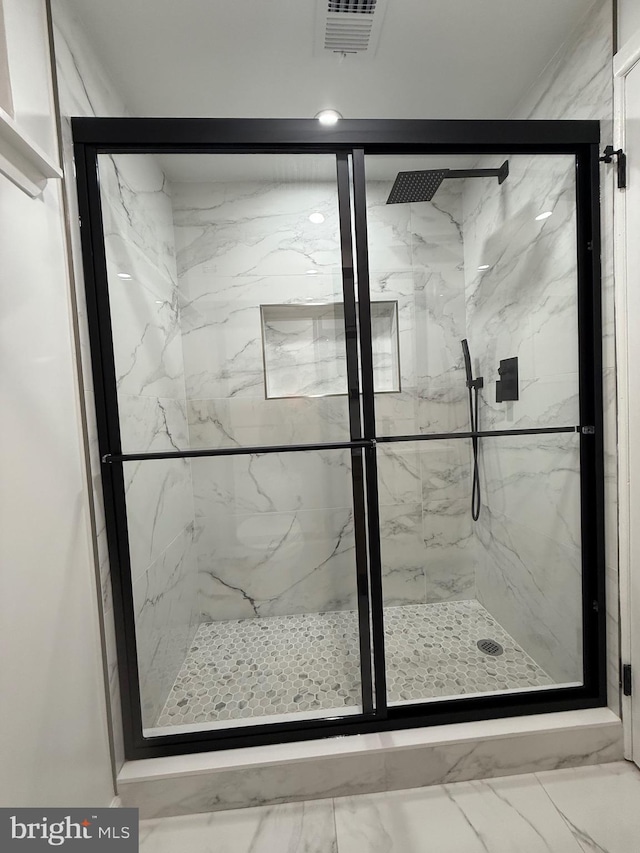 bathroom with a shower with shower door