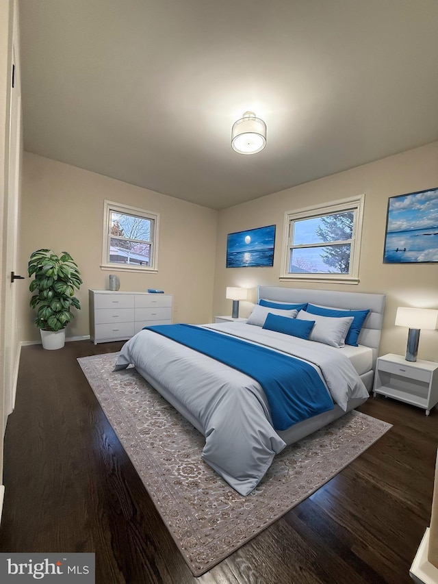 bedroom with dark hardwood / wood-style floors