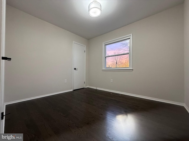 spare room featuring dark hardwood / wood-style floors