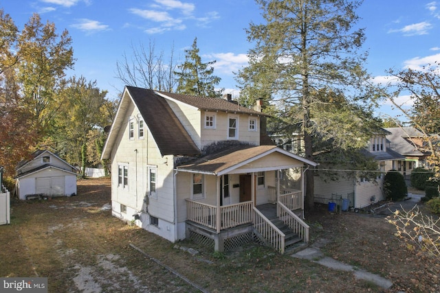 view of front of house with covered porch and a storage unit