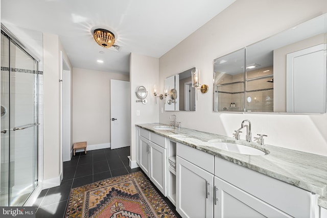 bathroom with tile patterned flooring, vanity, and a shower with door