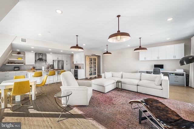 living room featuring beverage cooler and dark hardwood / wood-style flooring