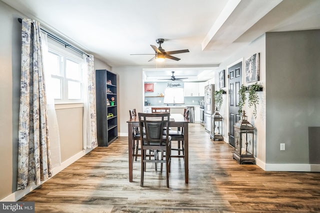 dining space with sink and hardwood / wood-style floors