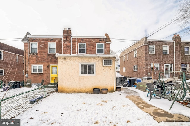 snow covered back of property with central air condition unit