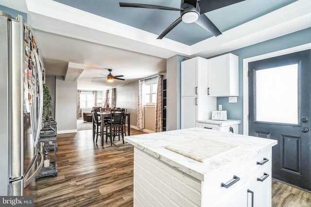 kitchen featuring a kitchen island, dark wood-type flooring, white cabinetry, and stainless steel fridge