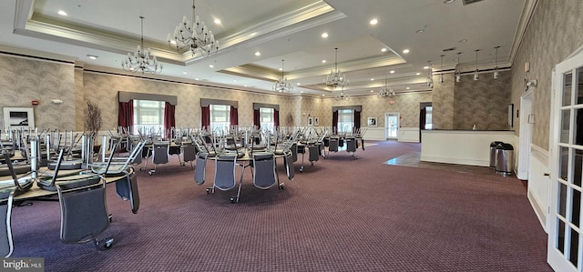 gym with a raised ceiling, recessed lighting, and ornamental molding