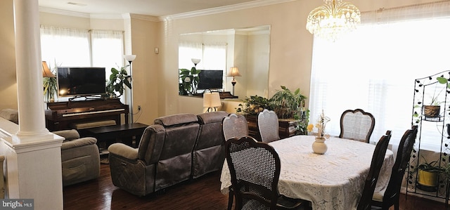 dining space featuring ornate columns, ornamental molding, a chandelier, and dark wood-style flooring