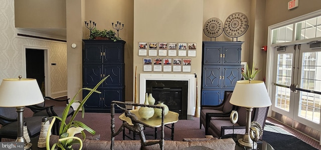 living room with a glass covered fireplace and french doors