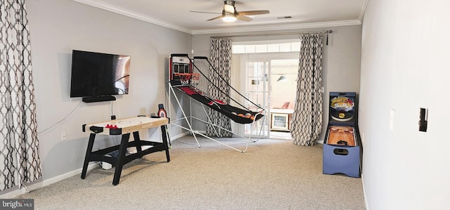 playroom featuring visible vents, baseboards, carpet, ornamental molding, and a ceiling fan