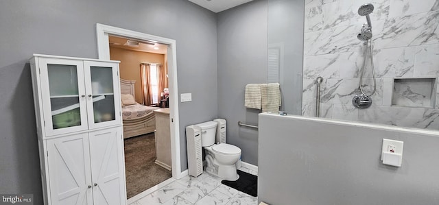 bathroom with toilet, marble finish floor, a walk in shower, connected bathroom, and baseboards