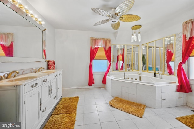 bathroom featuring ceiling fan, vanity, tiled bath, and tile patterned flooring