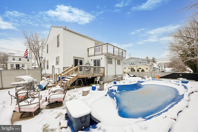 snow covered property featuring a wooden deck