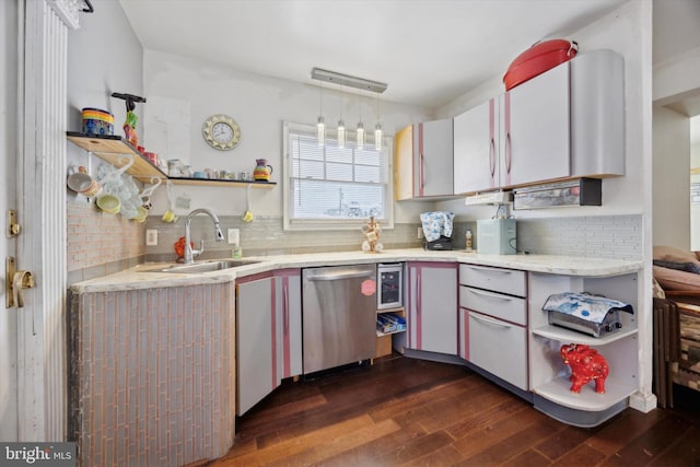 kitchen featuring sink, dishwasher, hanging light fixtures, backsplash, and dark hardwood / wood-style floors