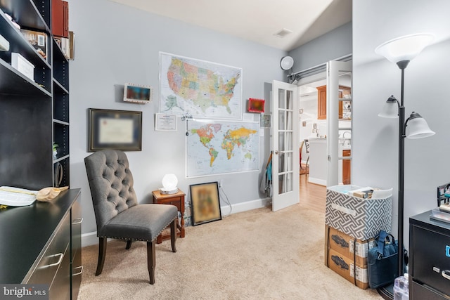 living area featuring light carpet and french doors