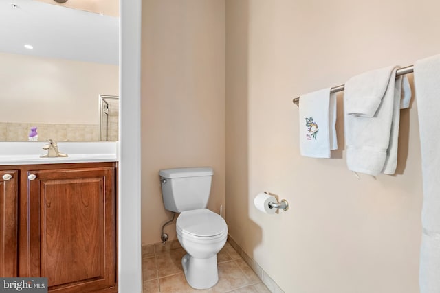 bathroom with vanity, tile patterned flooring, and toilet