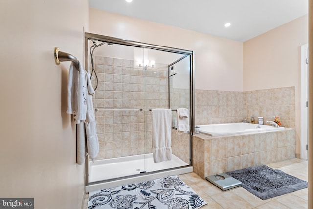 bathroom with tile patterned floors and shower with separate bathtub