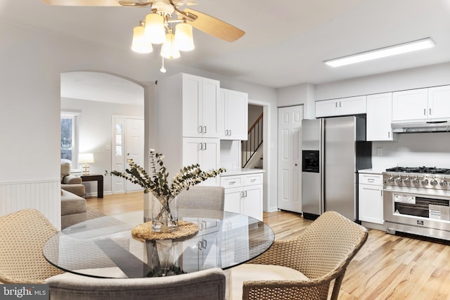 kitchen featuring stainless steel appliances, light hardwood / wood-style flooring, and white cabinets