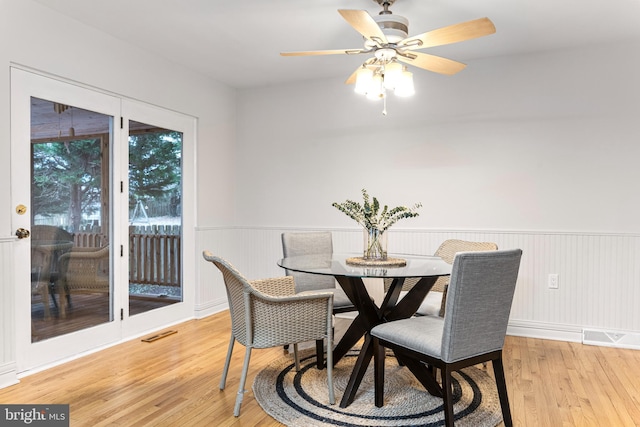 dining area with ceiling fan and light hardwood / wood-style floors