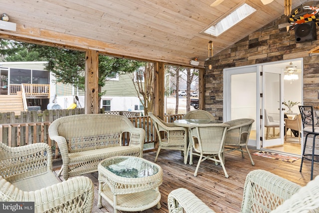 sunroom with wood ceiling and vaulted ceiling with skylight