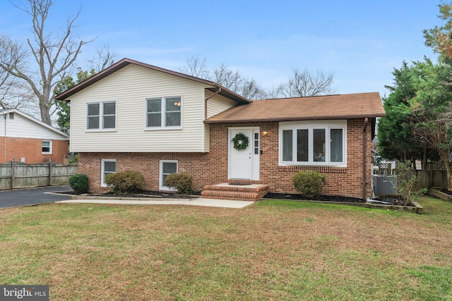 tri-level home with a front yard