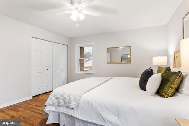 bedroom with ceiling fan, hardwood / wood-style floors, and a closet