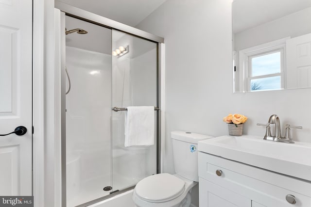 bathroom featuring walk in shower, vanity, and toilet