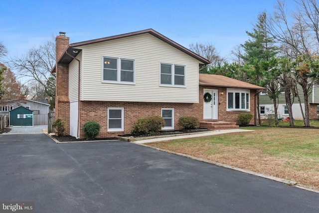 split level home featuring a front lawn