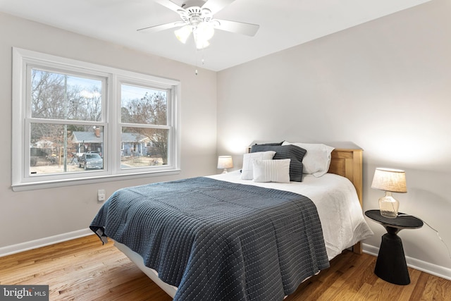 bedroom featuring hardwood / wood-style flooring and ceiling fan