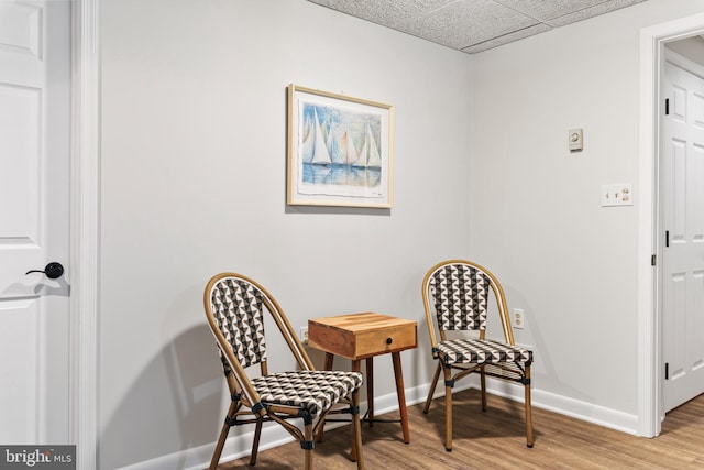 sitting room with wood-type flooring